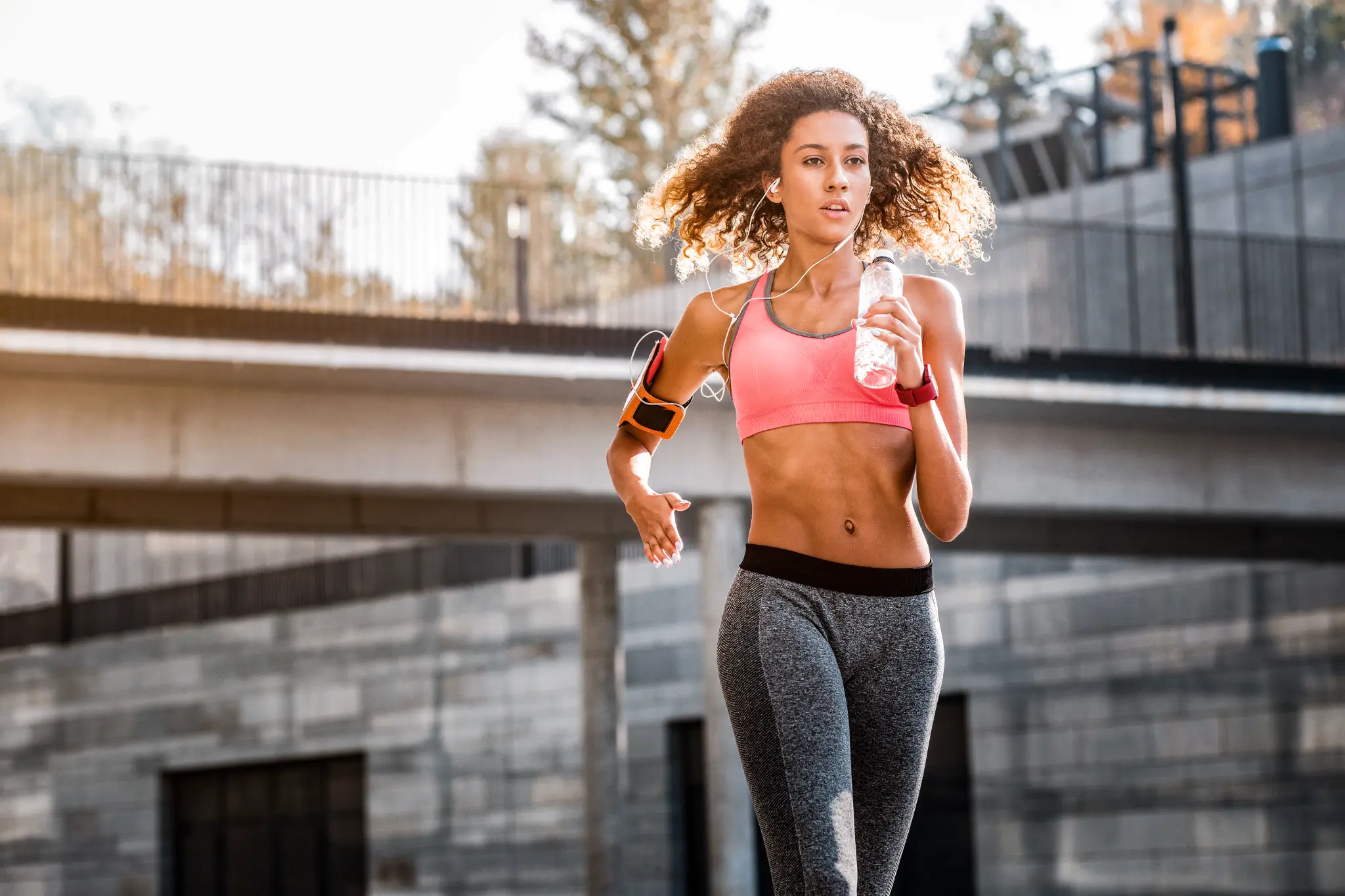 Woman running with water bottle